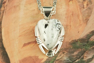 White Buffalo Turquoise set in Sterling Silver Pendant. This Beautiful Stone is formed from the minerals Calcite and Iron. It is mined near Tonopah Nevada. Free 18" Sterling Silver Chain with Purchase of Pendant. Created by Navajo Artist Phillip Sanchez. Signed by the artist.